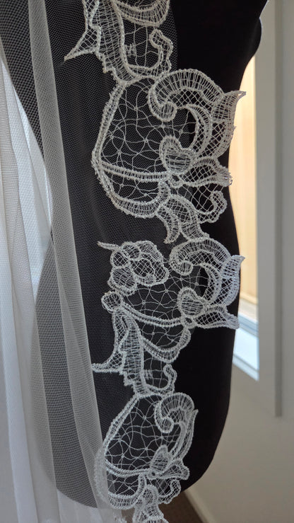 Close-up of an ivory lace detailing, mantilla veil short
